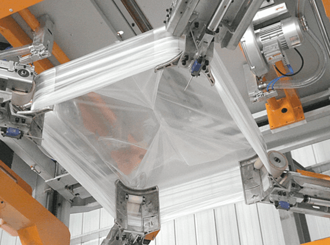 Automated stretch hood wrapping system