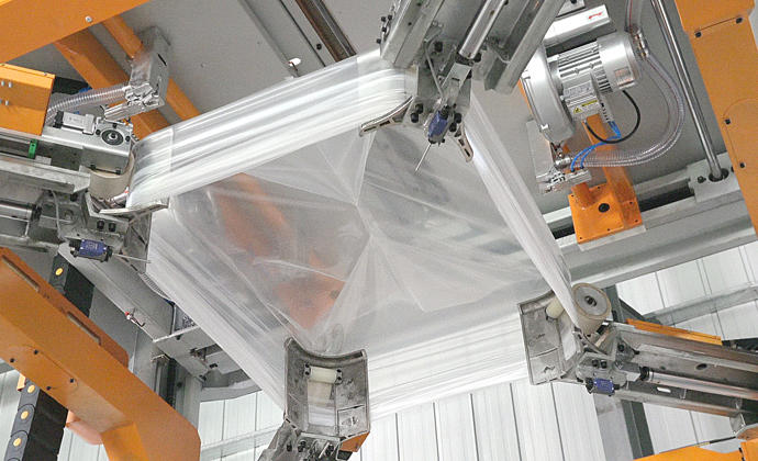 Automated stretch hood wrapping system